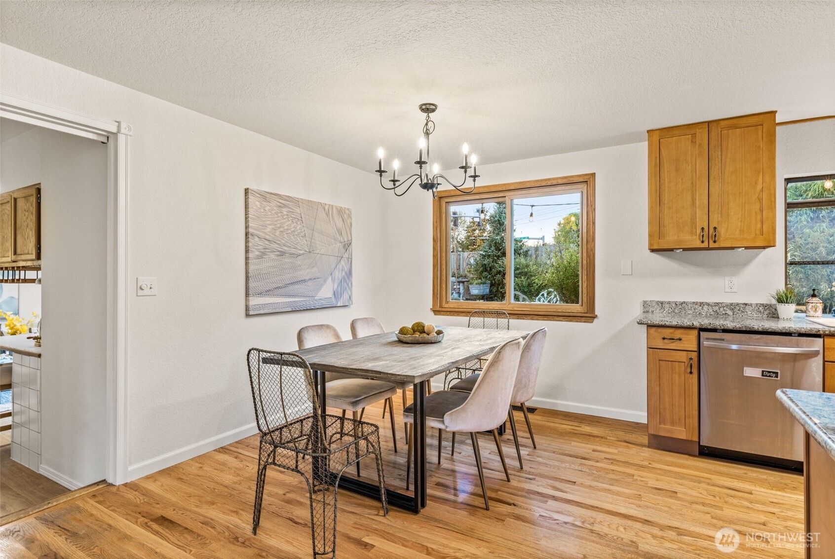 1313 228th Place Southwest Bothell, WA 98021 - Photo 4 of 23 a dining room with furniture a window and wooden floor