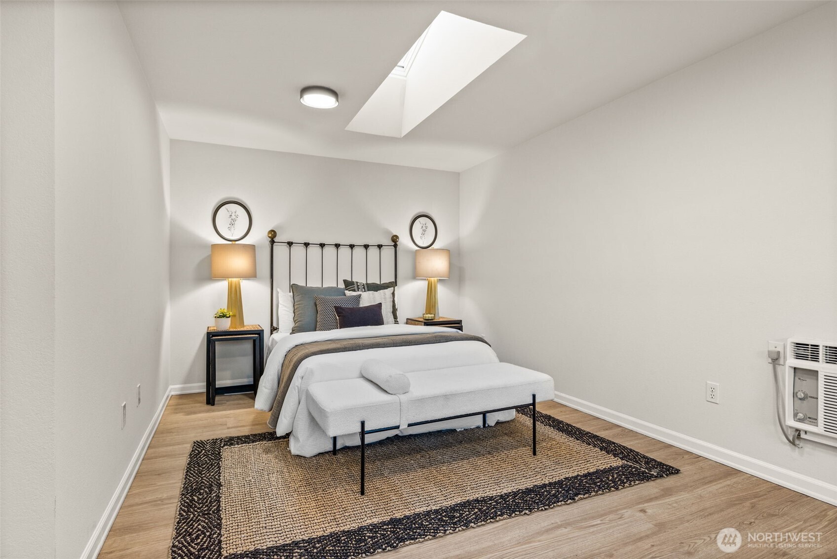 1313 228th Place Southwest Bothell, WA 98021 - Photo 10 of 23 a bedroom with a bed and a lamp with wooden floor