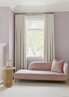 a living room with a bed and a window