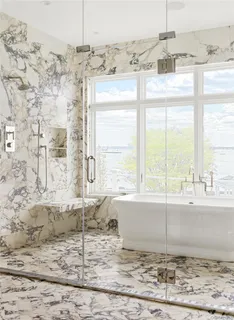 a bathroom with a granite countertop sink and a window