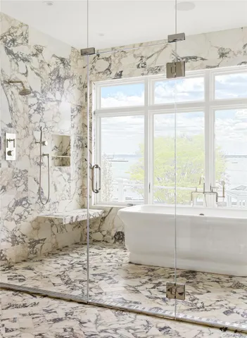 a bathroom with a granite countertop sink and a window