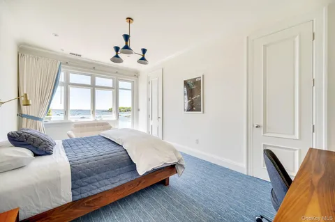 a bedroom with a large bed and a window