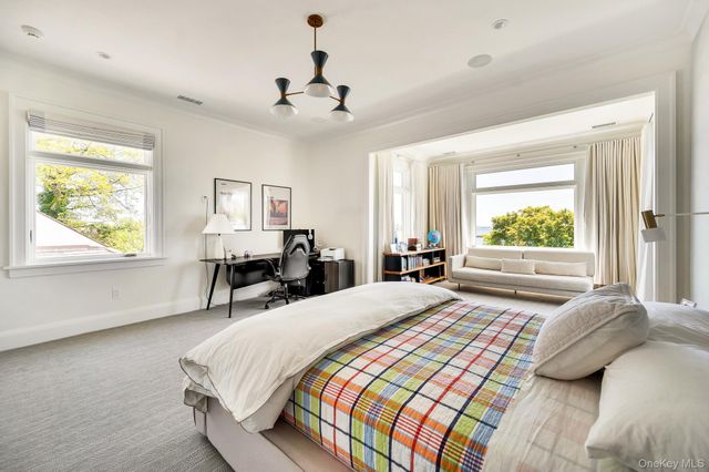 a bedroom with a large bed and a window