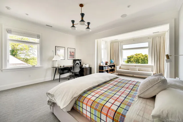 a bedroom with a large bed and a window