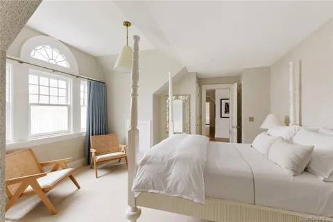 a bedroom with a bed and a chair