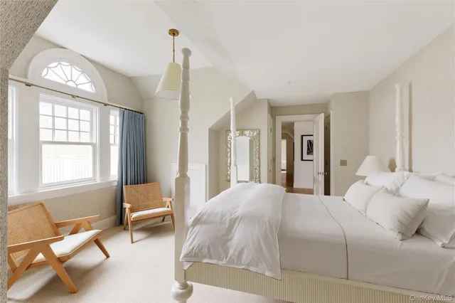 a bedroom with a bed and a chair