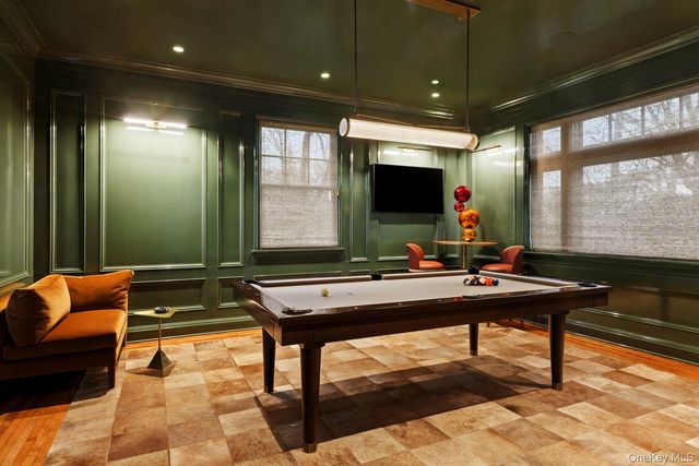 a room with furniture pool table and flat screen tv