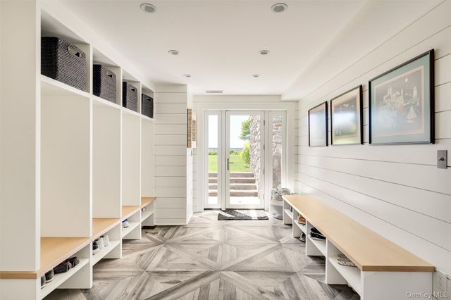 a spacious bathroom with a tub and large windows