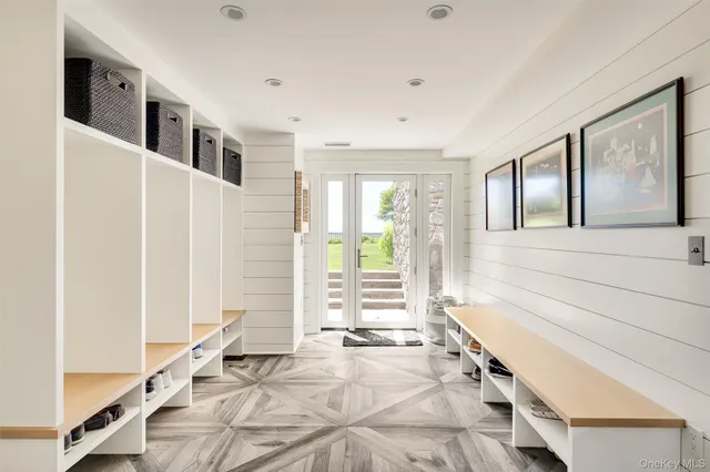 a spacious bathroom with a tub and large windows