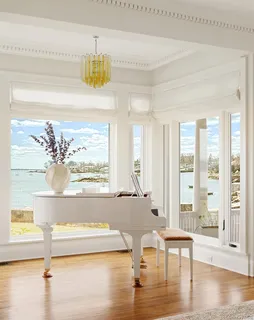a dining room with furniture window and wooden floor