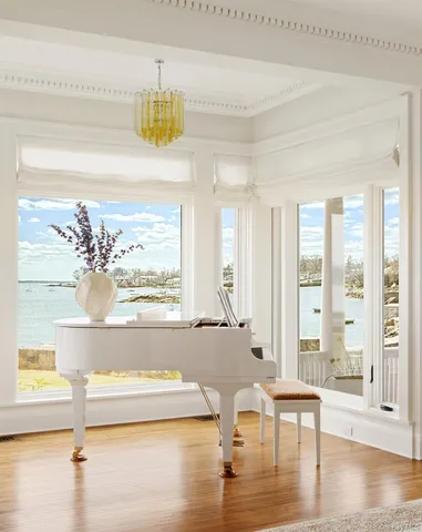 a dining room with furniture window and wooden floor