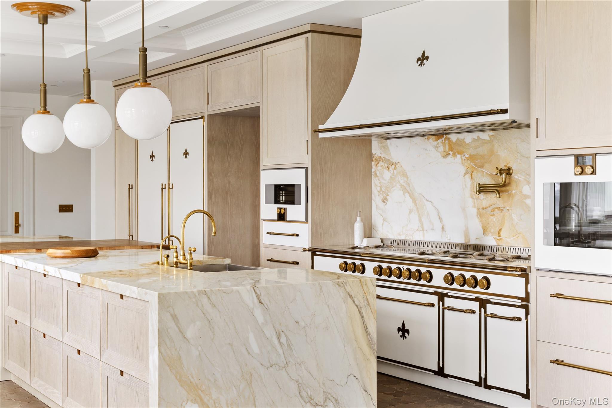 217 Hommocks Road Larchmont, NY 10538 - Photo 10 of 49 a kitchen with stainless steel appliances granite countertop a stove and white cabinets with wooden floor