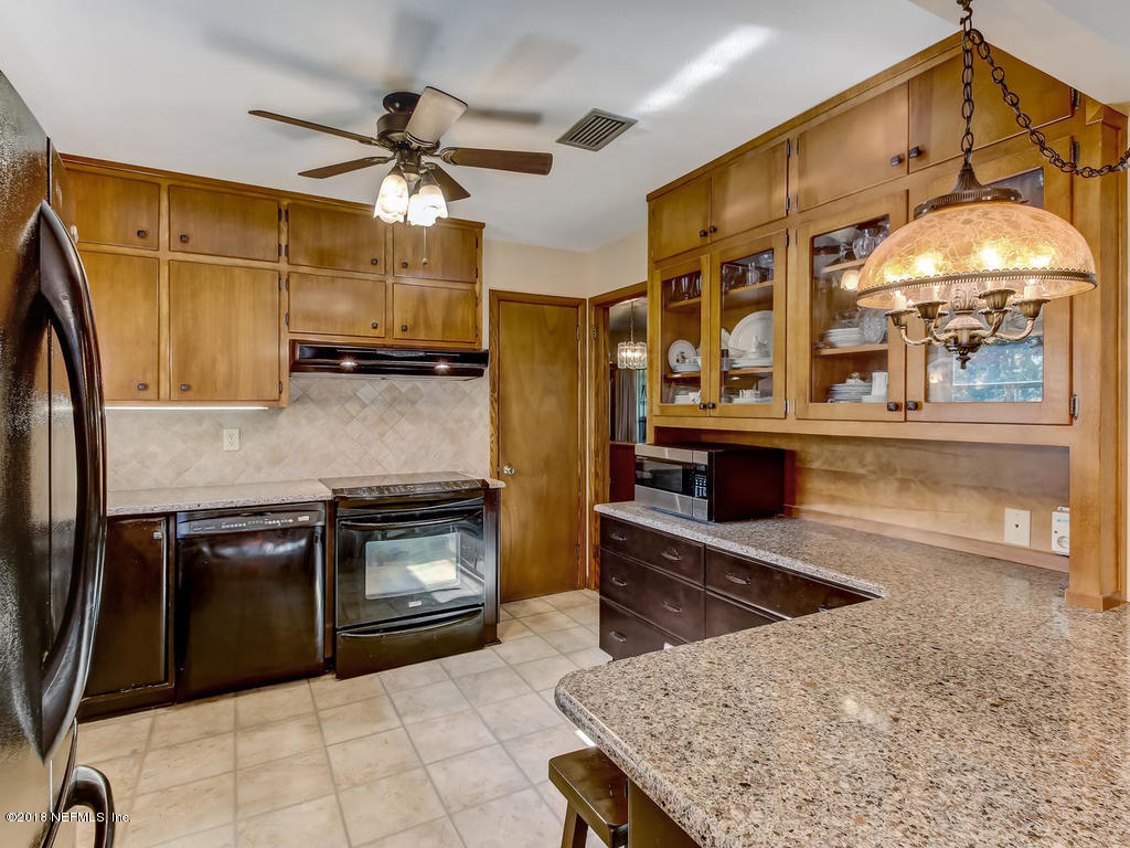 1321 Morgana Road Jacksonville, FL 32211 - Photo 13 of 44 a kitchen with stainless steel appliances granite countertop a stove a refrigerator and a microwave
