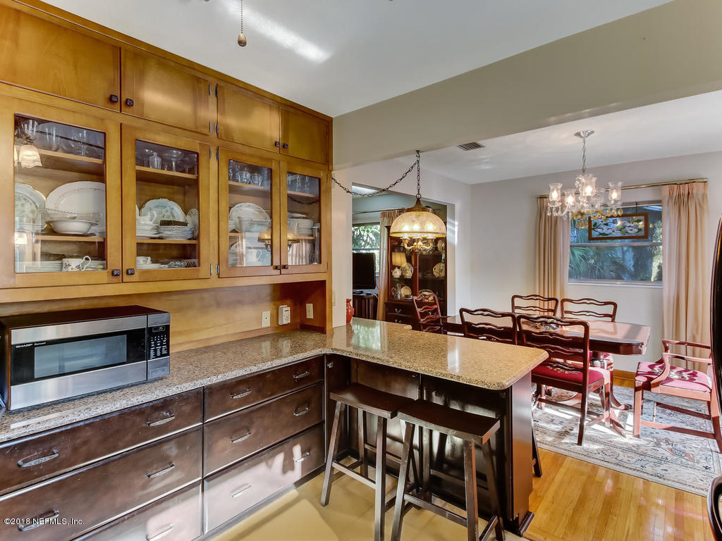 1321 Morgana Road Jacksonville, FL 32211 - Photo 15 of 44 a kitchen with a table chairs stove and cabinets