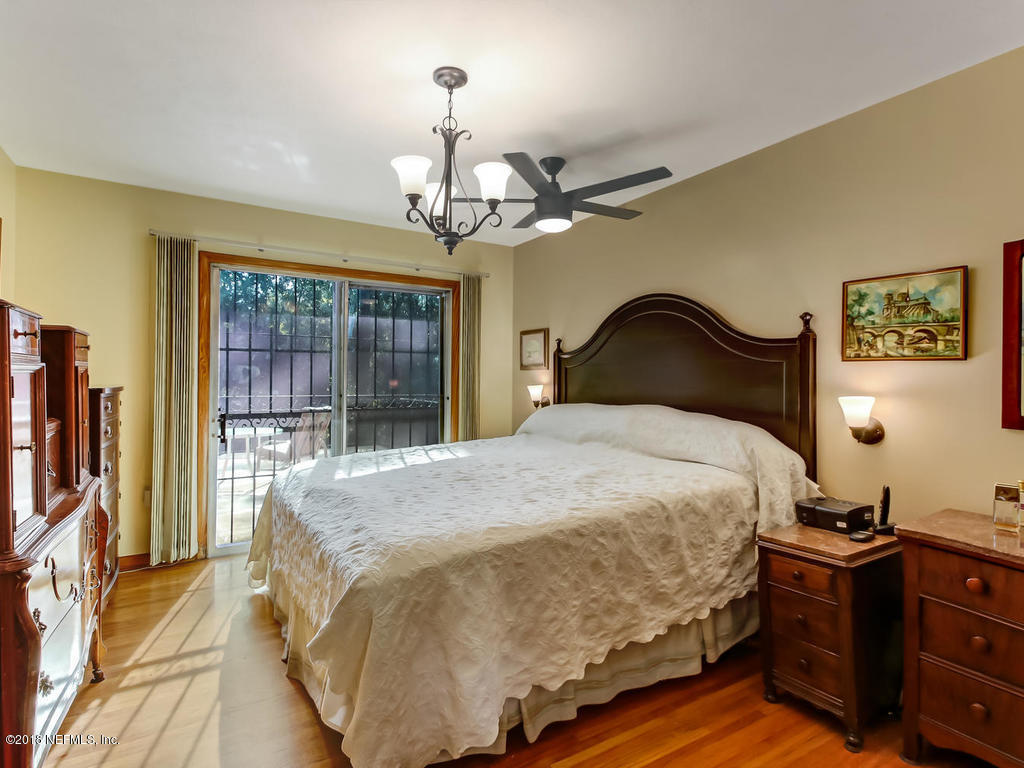 1321 Morgana Road Jacksonville, FL 32211 - Photo 18 of 44 a bedroom with a bed chandelier and a window