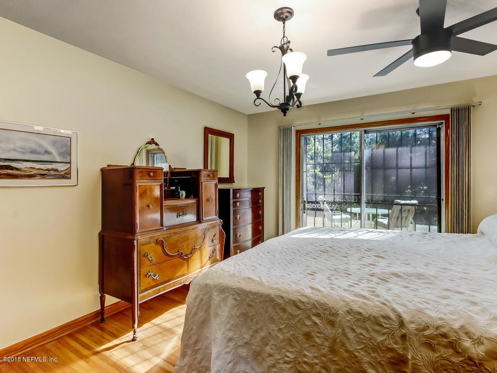 1321 Morgana Road Jacksonville, FL 32211 - Photo 19 of 44 a spacious bedroom with a bed and a chandelier