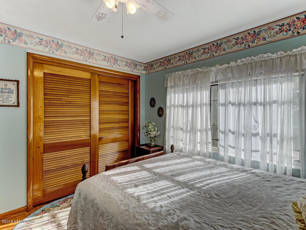 1321 Morgana Road Jacksonville, FL 32211 - Photo 26 of 44 a bedroom with a bed and a chandelier