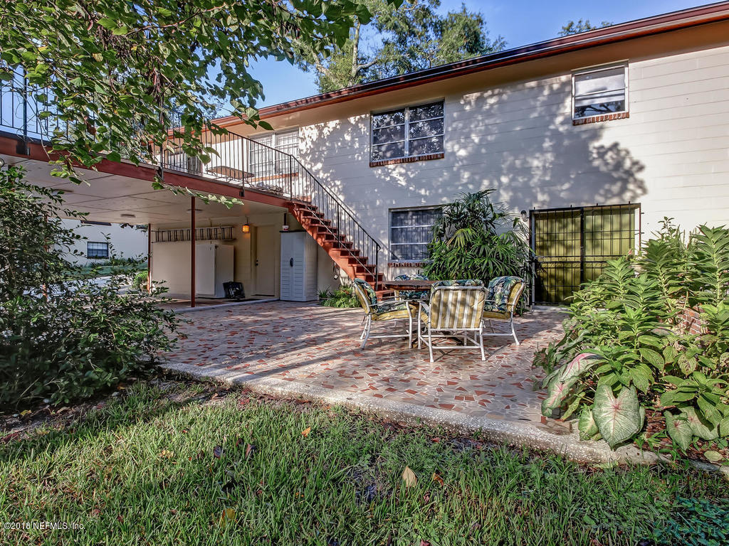 1321 Morgana Road Jacksonville, FL 32211 - Photo 43 of 44 a view of a patio with table and chairs potted plants and large tree