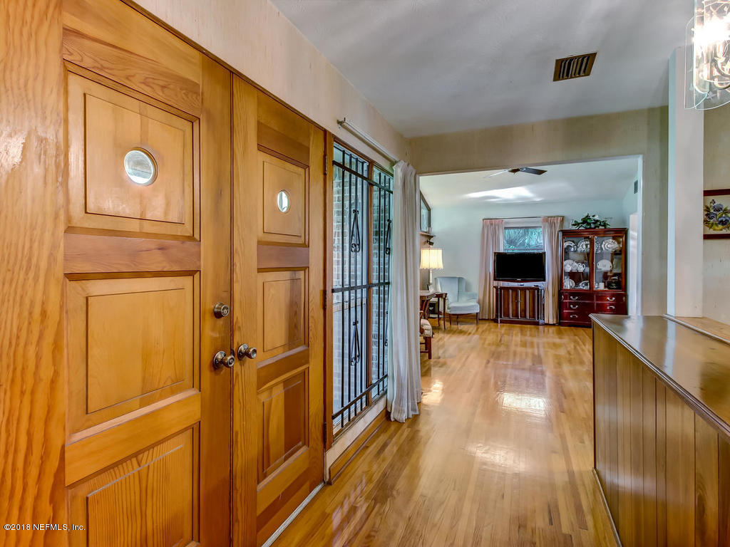 1321 Morgana Road Jacksonville, FL 32211 - Photo 6 of 44 a view of a hallway with wooden floor and a cabinet