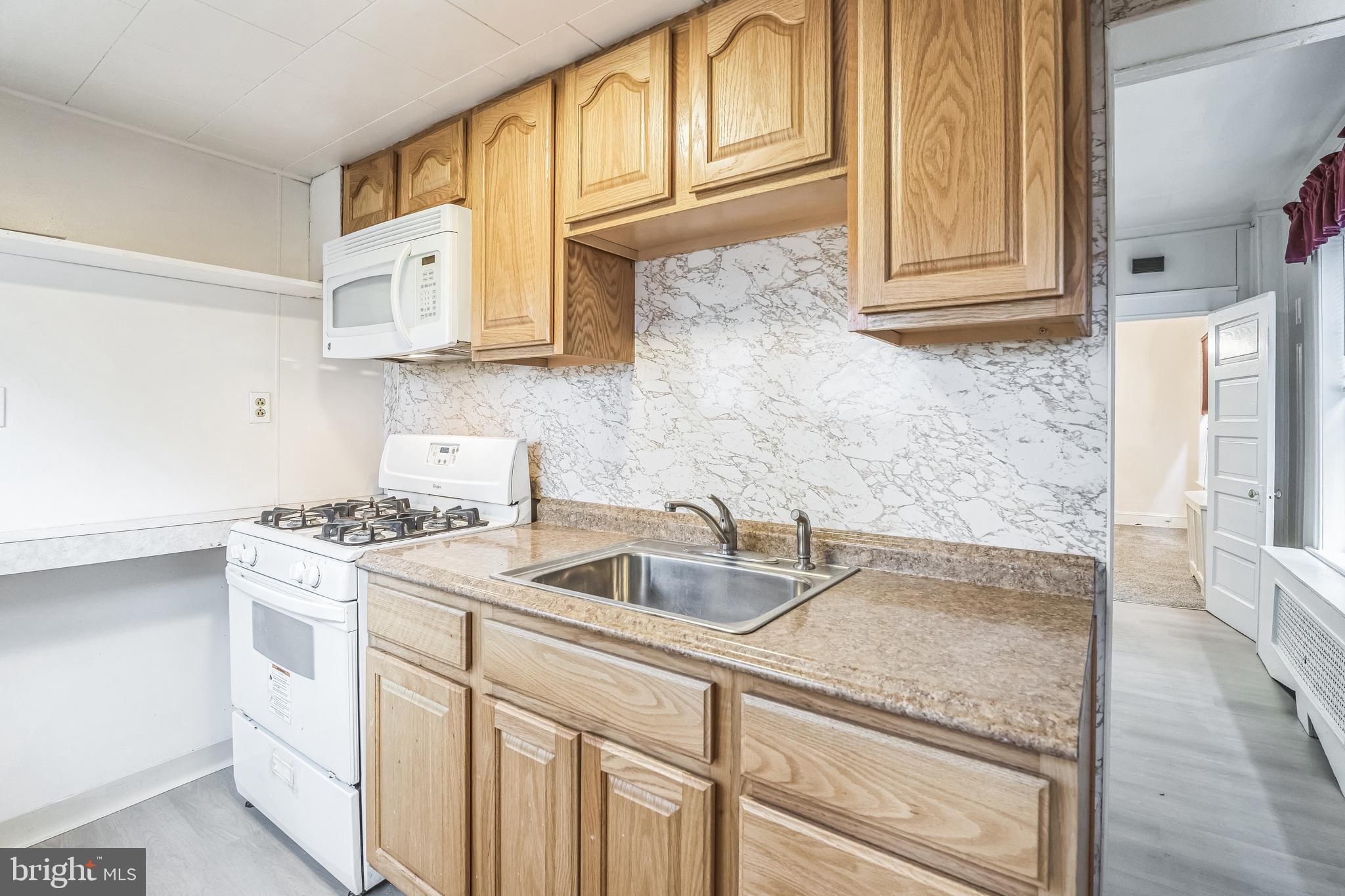 415 Rector Street Philadelphia, PA 19128 - Photo 15 of 31 a kitchen with stainless steel appliances granite countertop a sink stove and cabinets