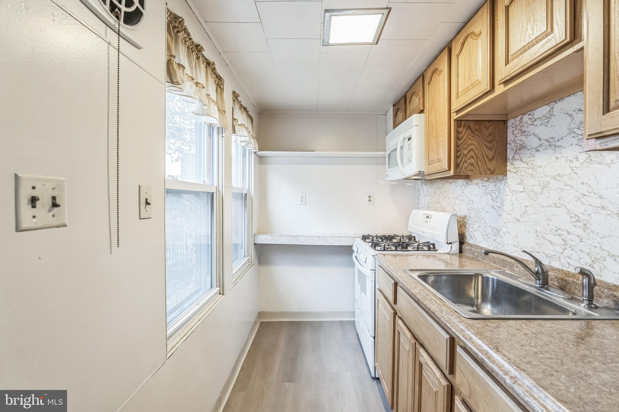 415 Rector Street Philadelphia, PA 19128 - Photo 16 of 31 a kitchen with stainless steel appliances granite countertop a sink and a refrigerator