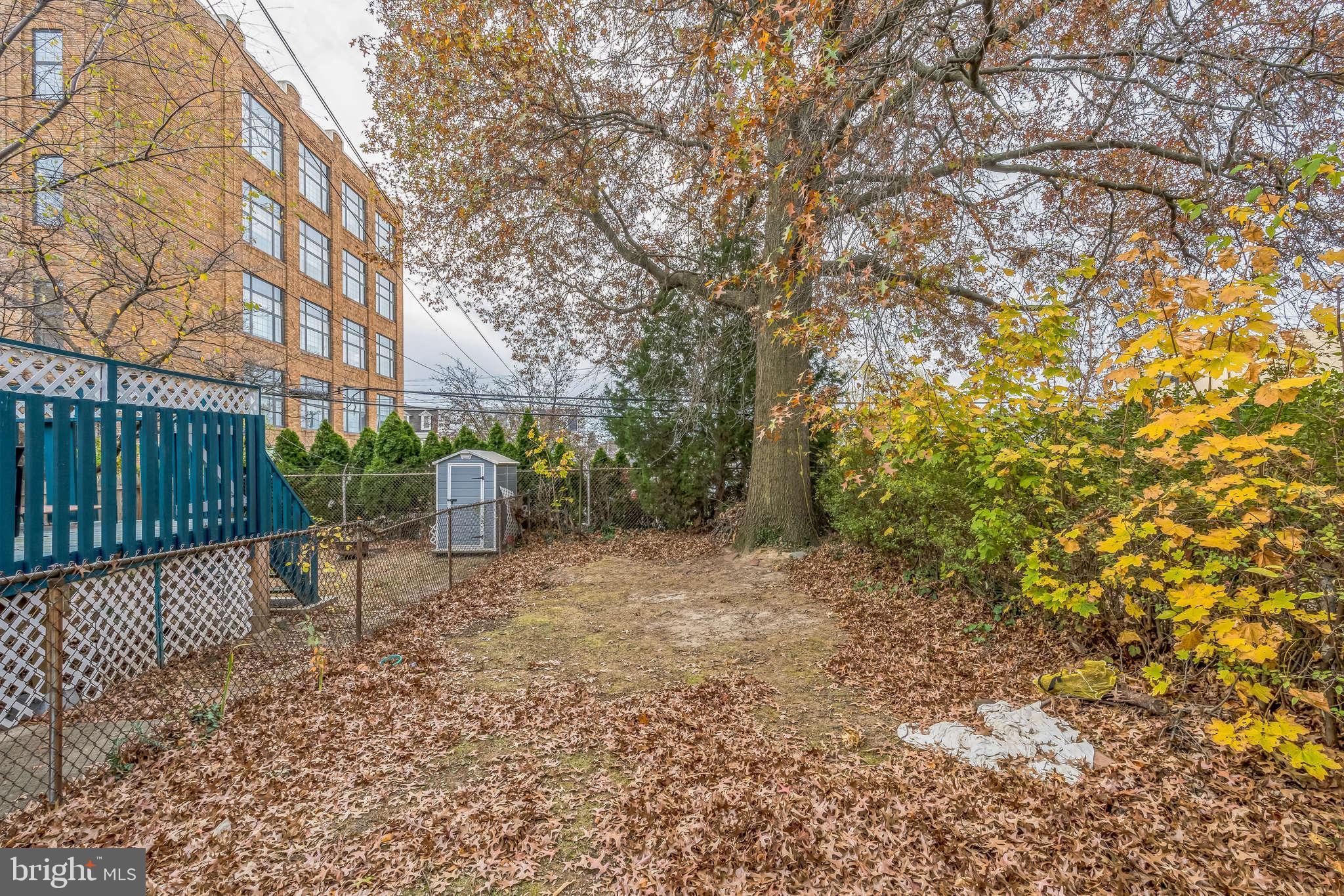 415 Rector Street Philadelphia, PA 19128 - Photo 17 of 31 a view of a yard with plants and wooden fence