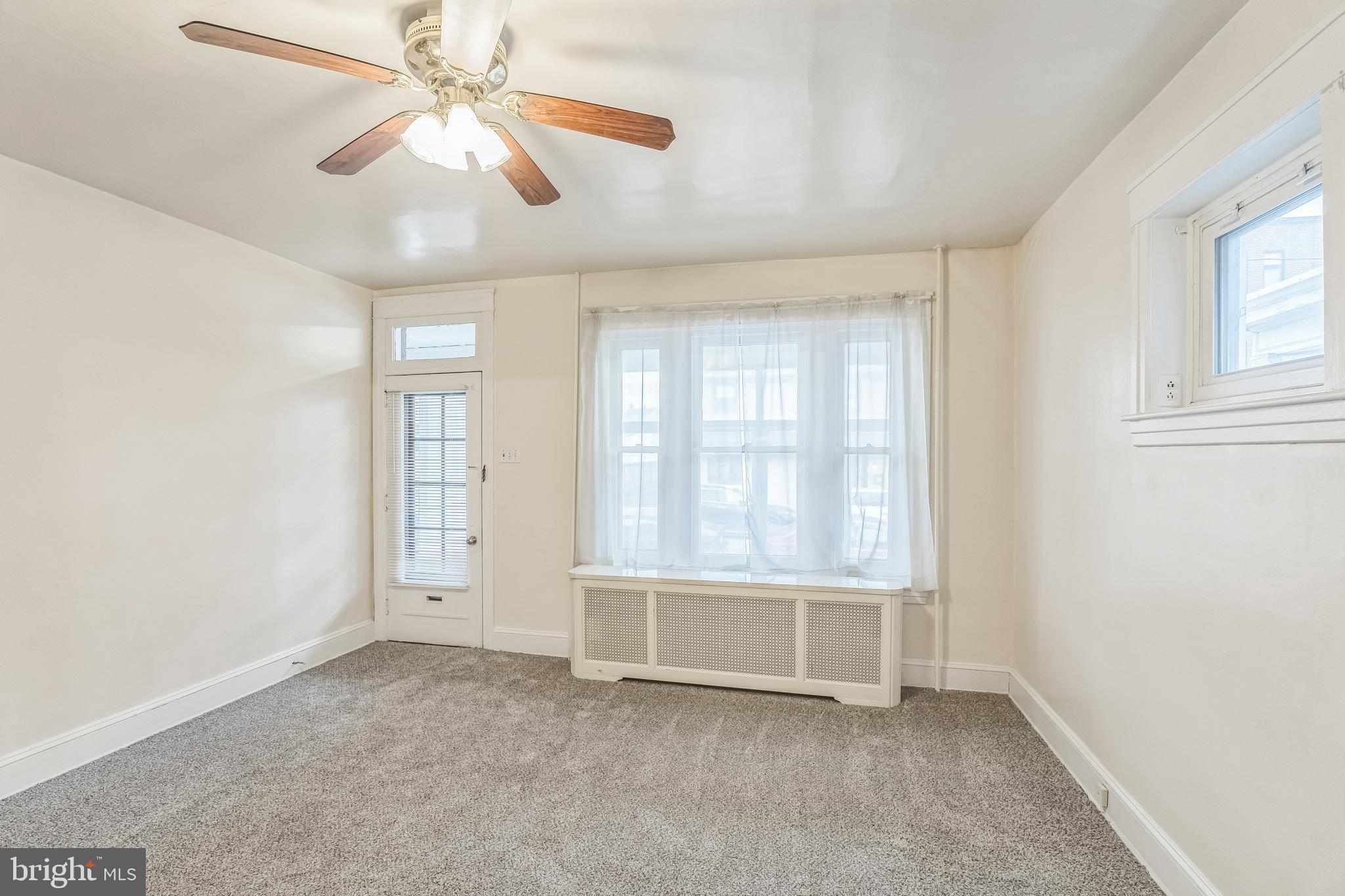 415 Rector Street Philadelphia, PA 19128 - Photo 5 of 31 an empty room with chandelier fan and windows