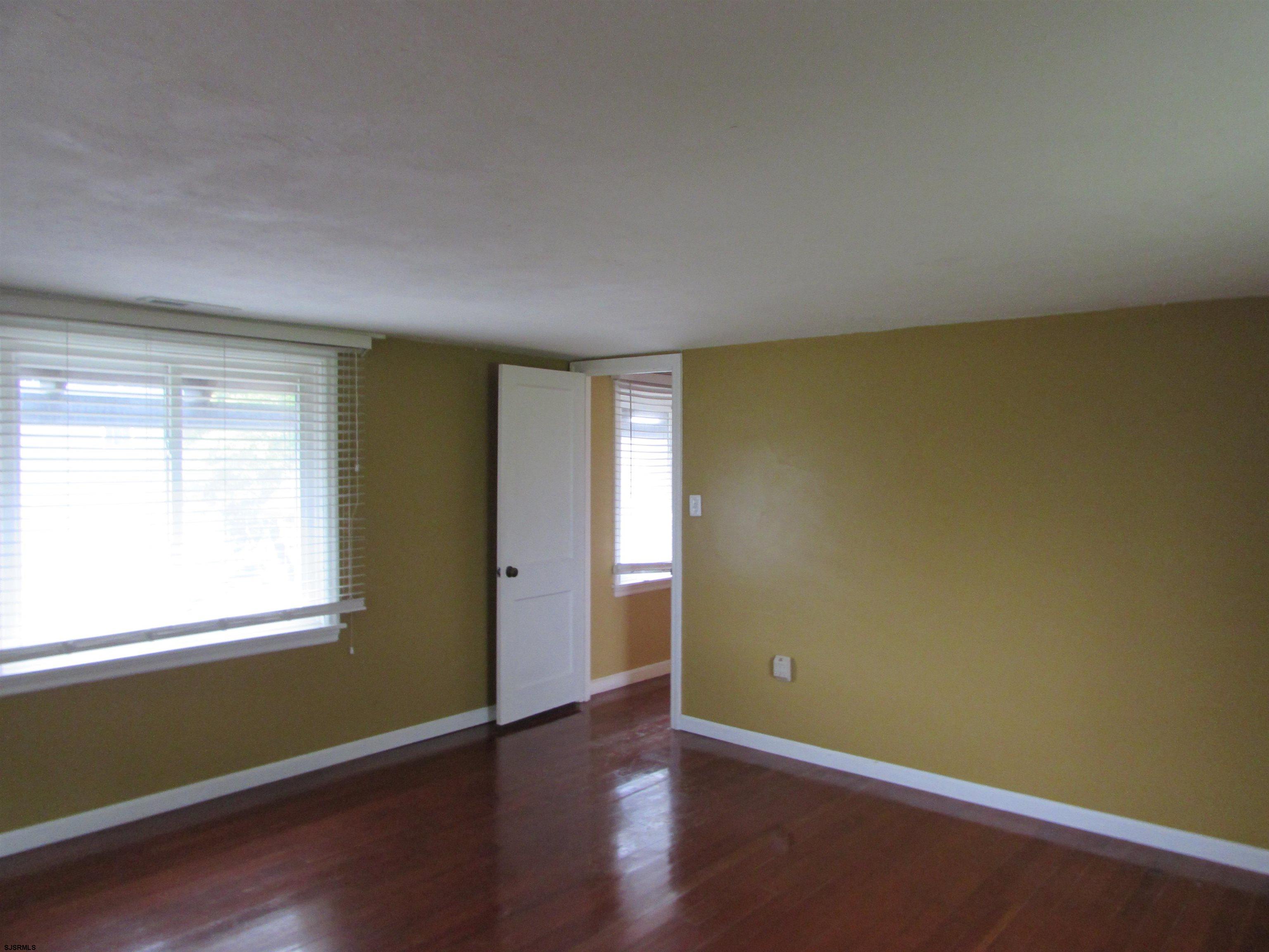 744 Shore Road Linwood, NJ 08221 - Photo 29 of 43 an empty room with wooden floor and windows