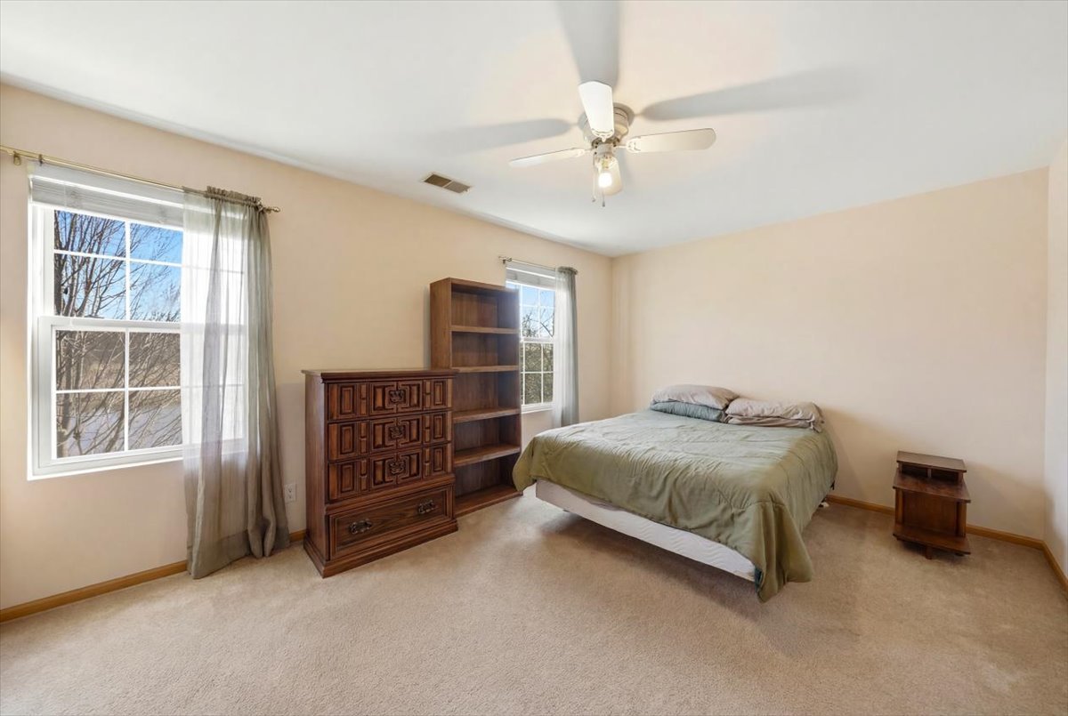 2542 Oak Tree Lane Plainfield, IL 60586 - Photo 12 of 20 a bedroom with a bed and cabinet