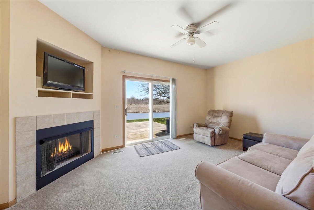 2542 Oak Tree Lane Plainfield, IL 60586 - Photo 4 of 20 a living room with furniture and a fireplace