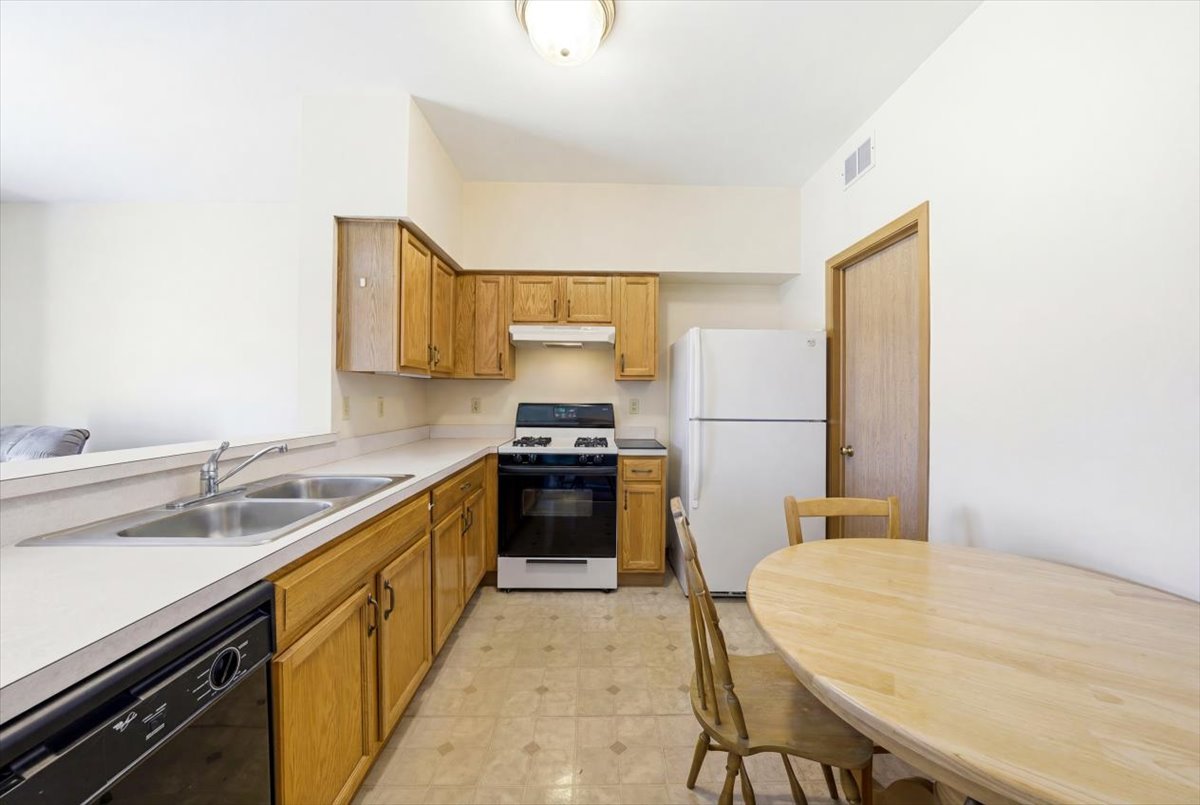 2542 Oak Tree Lane Plainfield, IL 60586 - Photo 8 of 20 a kitchen with a sink a stove and cabinets