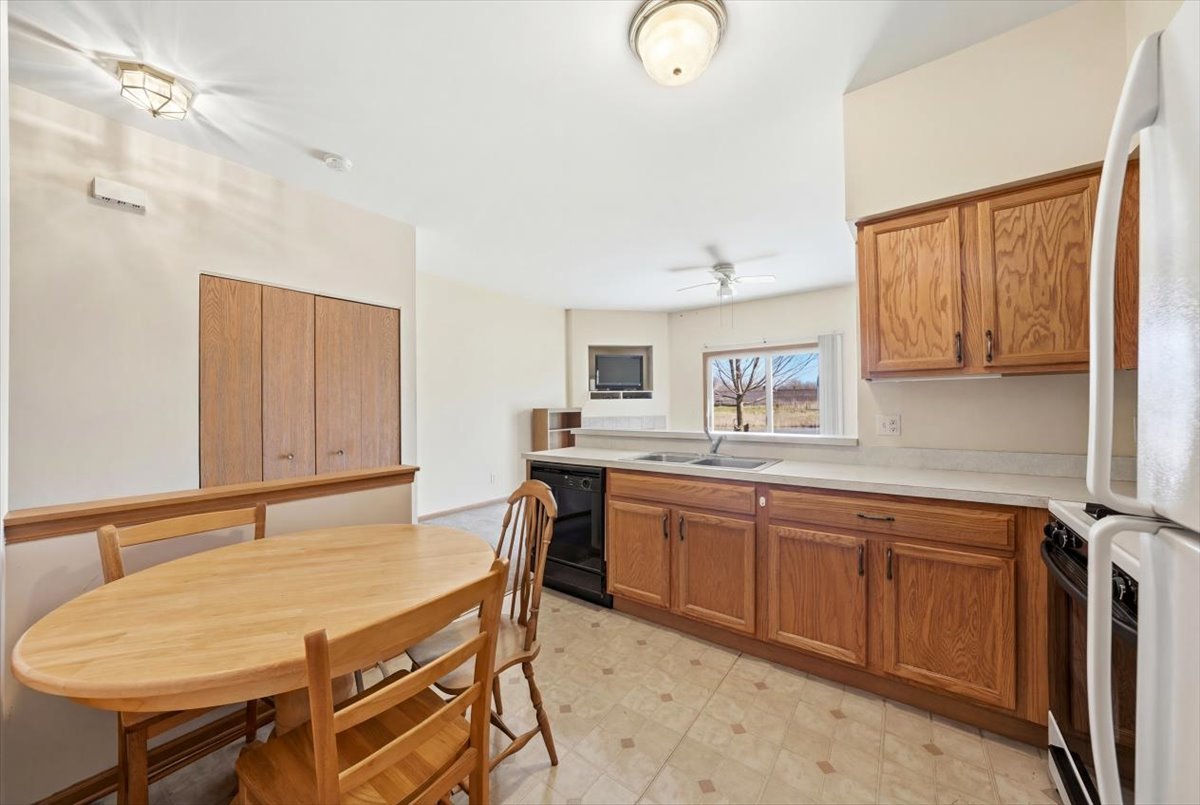 2542 Oak Tree Lane Plainfield, IL 60586 - Photo 9 of 20 a view of a kitchen area with furniture and wooden floor