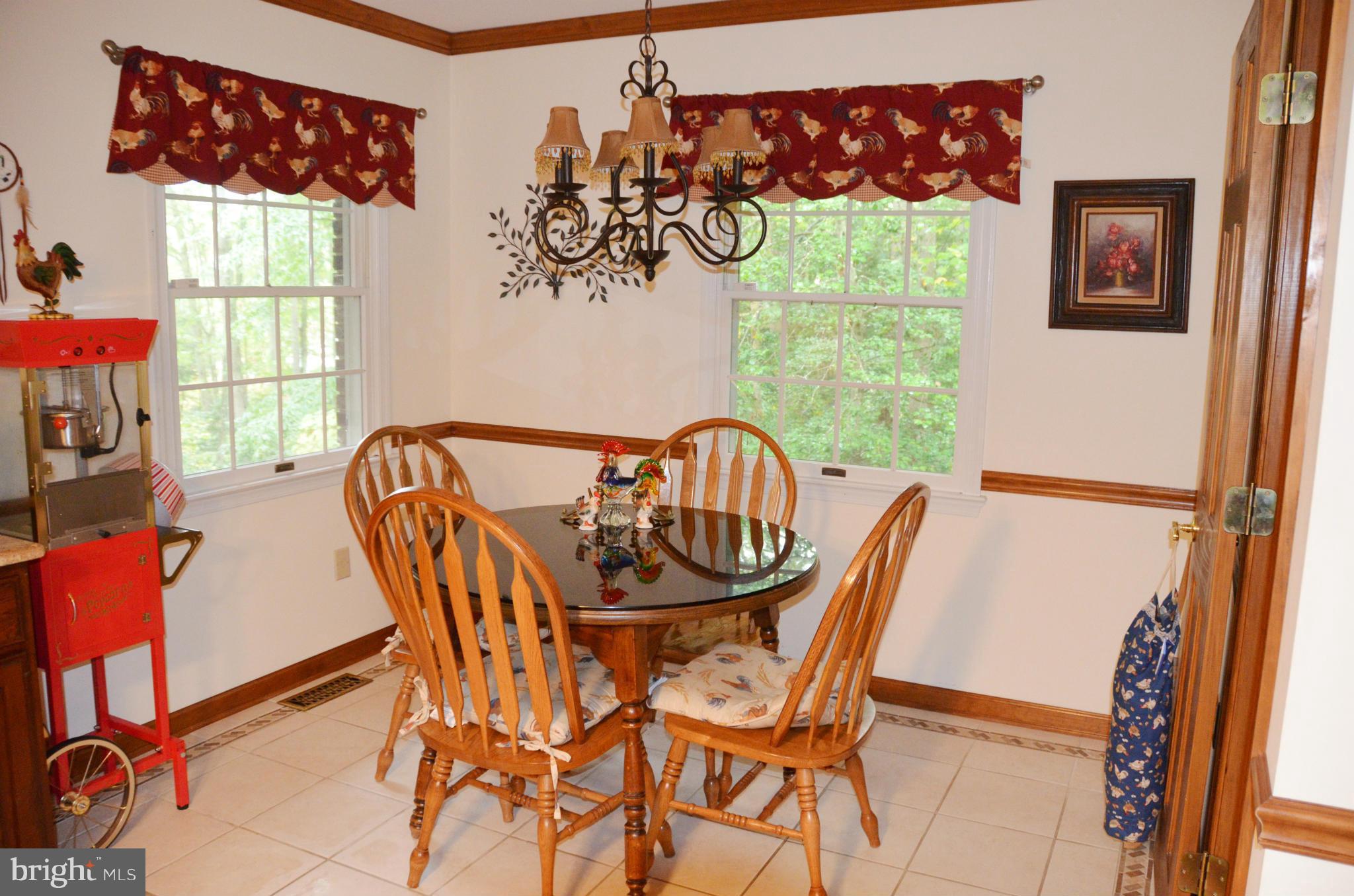 12717 Blair Road Lusby, MD 20657 - Photo 27 of 30 a view of a dining room with furniture and a window
