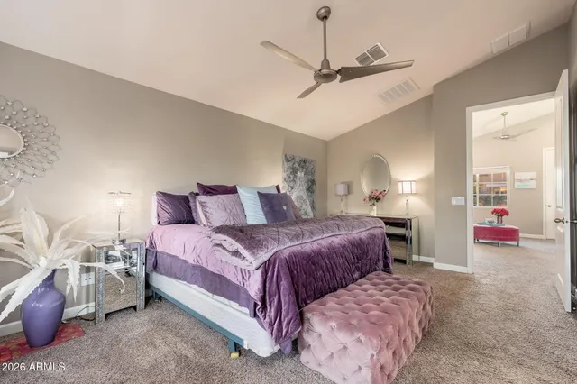 a bedroom with bed and a chandelier
