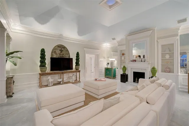 a view of a dining room with furniture a chandelier and wooden floor