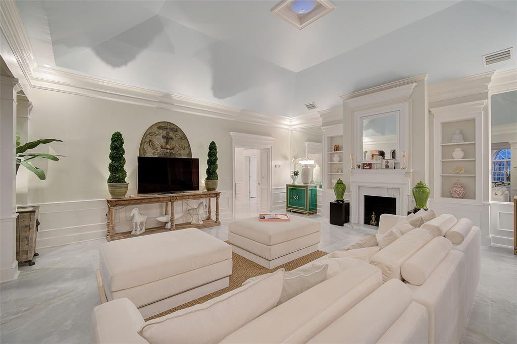 75 Osprey Point Drive Osprey, FL 34229 - Photo 19 of 92 a living room with furniture a fireplace and a flat screen tv