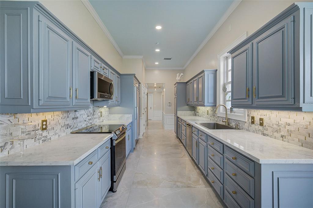 75 Osprey Point Drive Osprey, FL 34229 - Photo 24 of 92 a kitchen with stainless steel appliances granite countertop a sink stove and cabinets