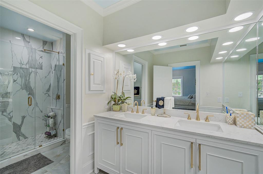 75 Osprey Point Drive Osprey, FL 34229 - Photo 36 of 92 a bathroom with a double vanity sink mirror and shower