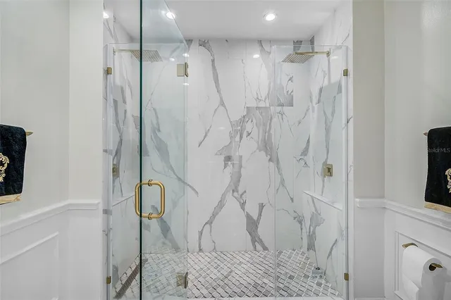 a front view of a house with a garden and trees