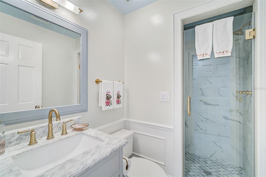 75 Osprey Point Drive Osprey, FL 34229 - Photo 46 of 92 a bathroom with a granite countertop sink a toilet and shower