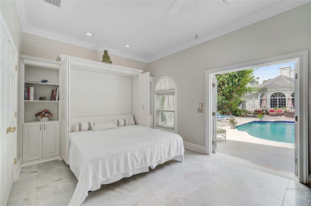 75 Osprey Point Drive Osprey, FL 34229 - Photo 54 of 92 a bedroom with a large bed and a large window