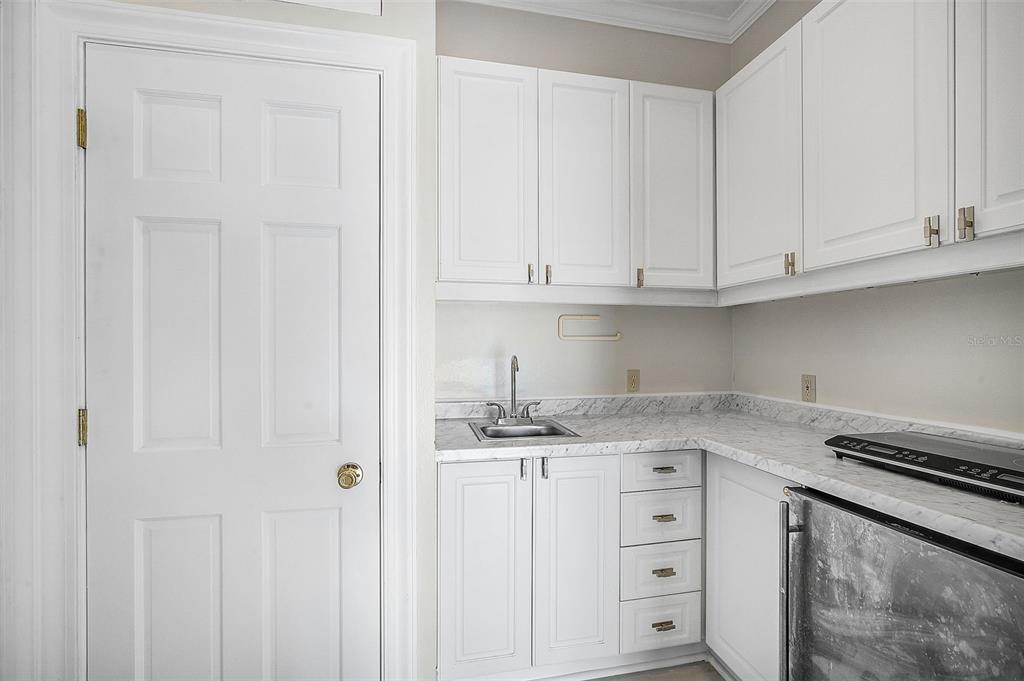 75 Osprey Point Drive Osprey, FL 34229 - Photo 56 of 92 a kitchen with granite countertop white cabinets and sink