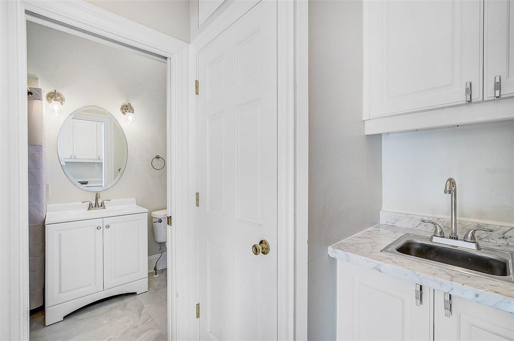 75 Osprey Point Drive Osprey, FL 34229 - Photo 57 of 92 a bathroom with a sink and a mirror