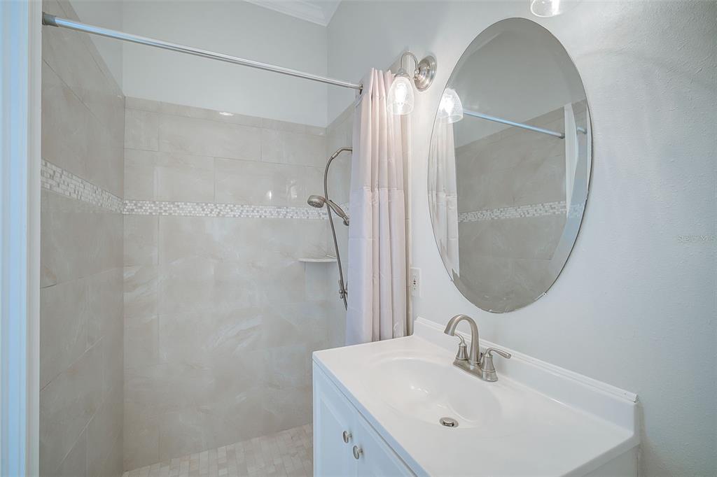 75 Osprey Point Drive Osprey, FL 34229 - Photo 58 of 92 a bathroom with a sink mirror and vanity