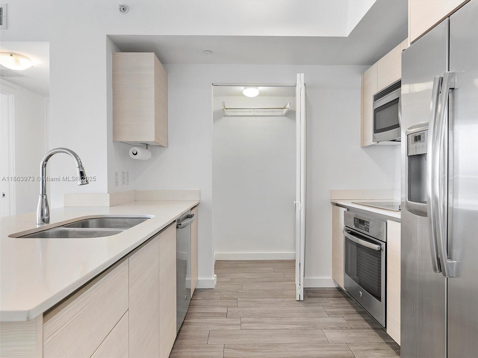4250 Biscayne Boulevard, Unit 1416 Miami, FL 33137 - Photo 13 of 55 a kitchen with stainless steel appliances granite countertop a sink stove and refrigerator