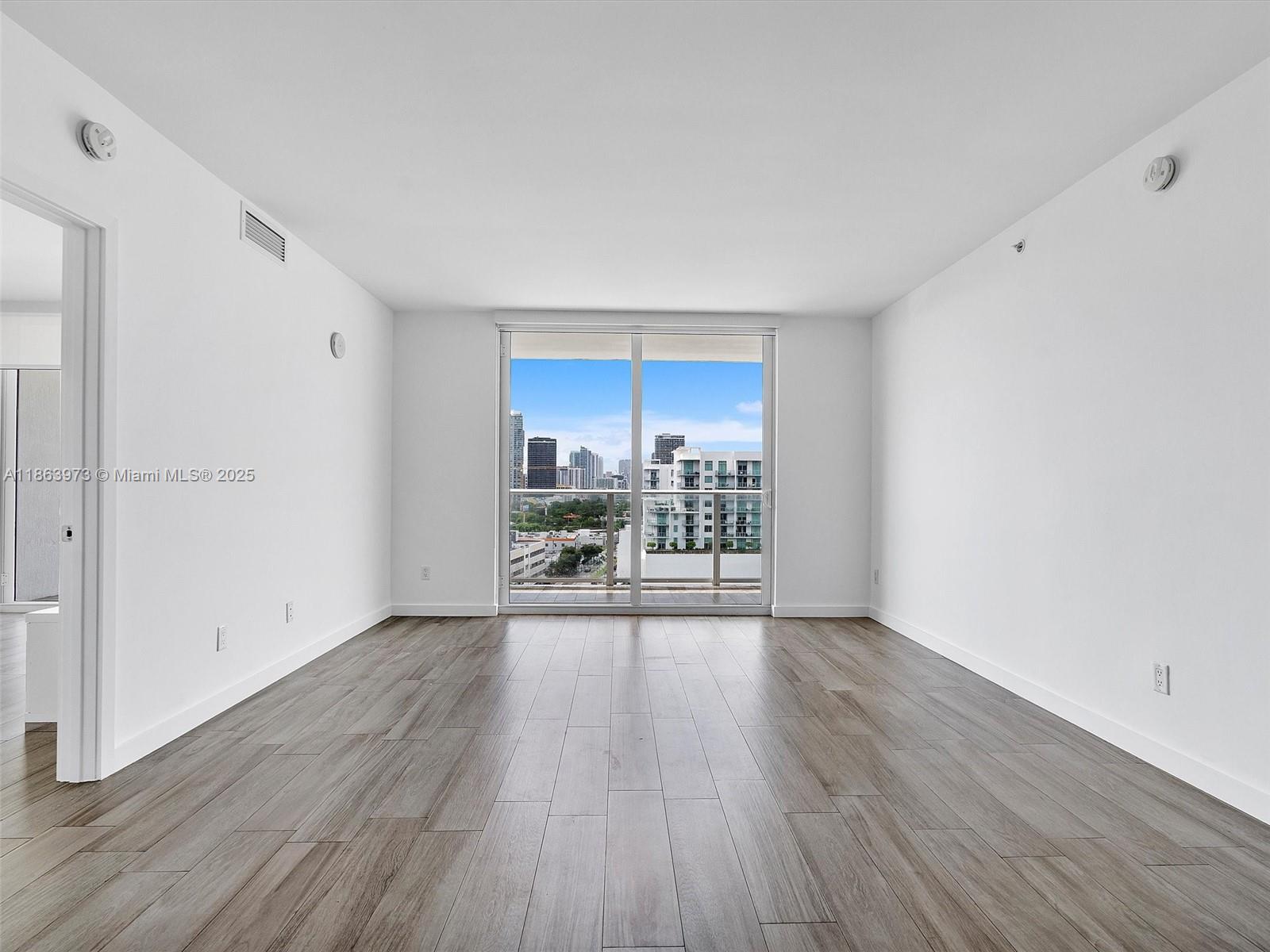 4250 Biscayne Boulevard, Unit 1416 Miami, FL 33137 - Photo 16 of 55 a view of a room with wooden floor and a window