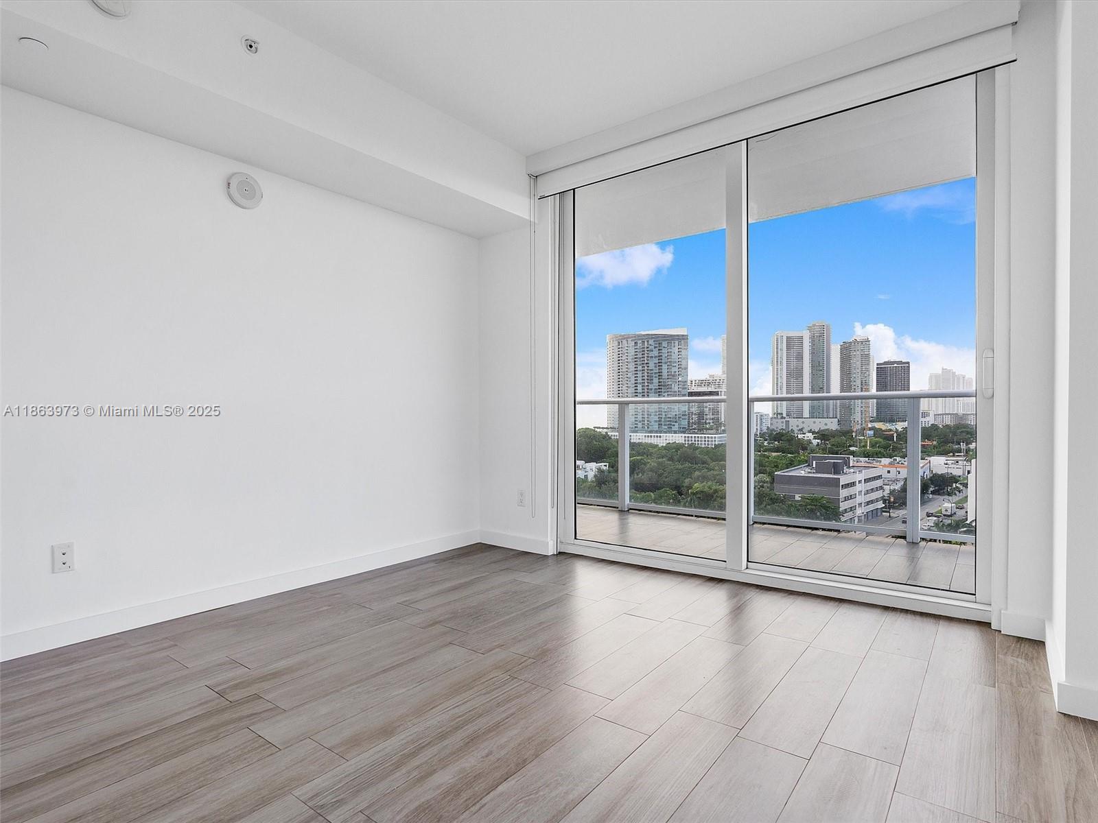 4250 Biscayne Boulevard, Unit 1416 Miami, FL 33137 - Photo 18 of 55 a view of a city from a big room with wooden floor pool table and windows