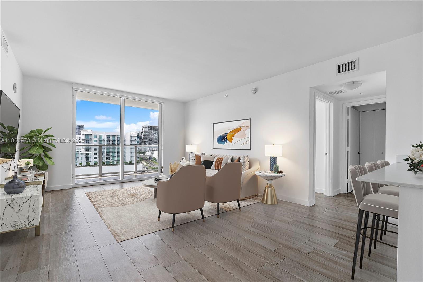 4250 Biscayne Boulevard, Unit 1416 Miami, FL 33137 - Photo 2 of 55 a living room with furniture and a large window