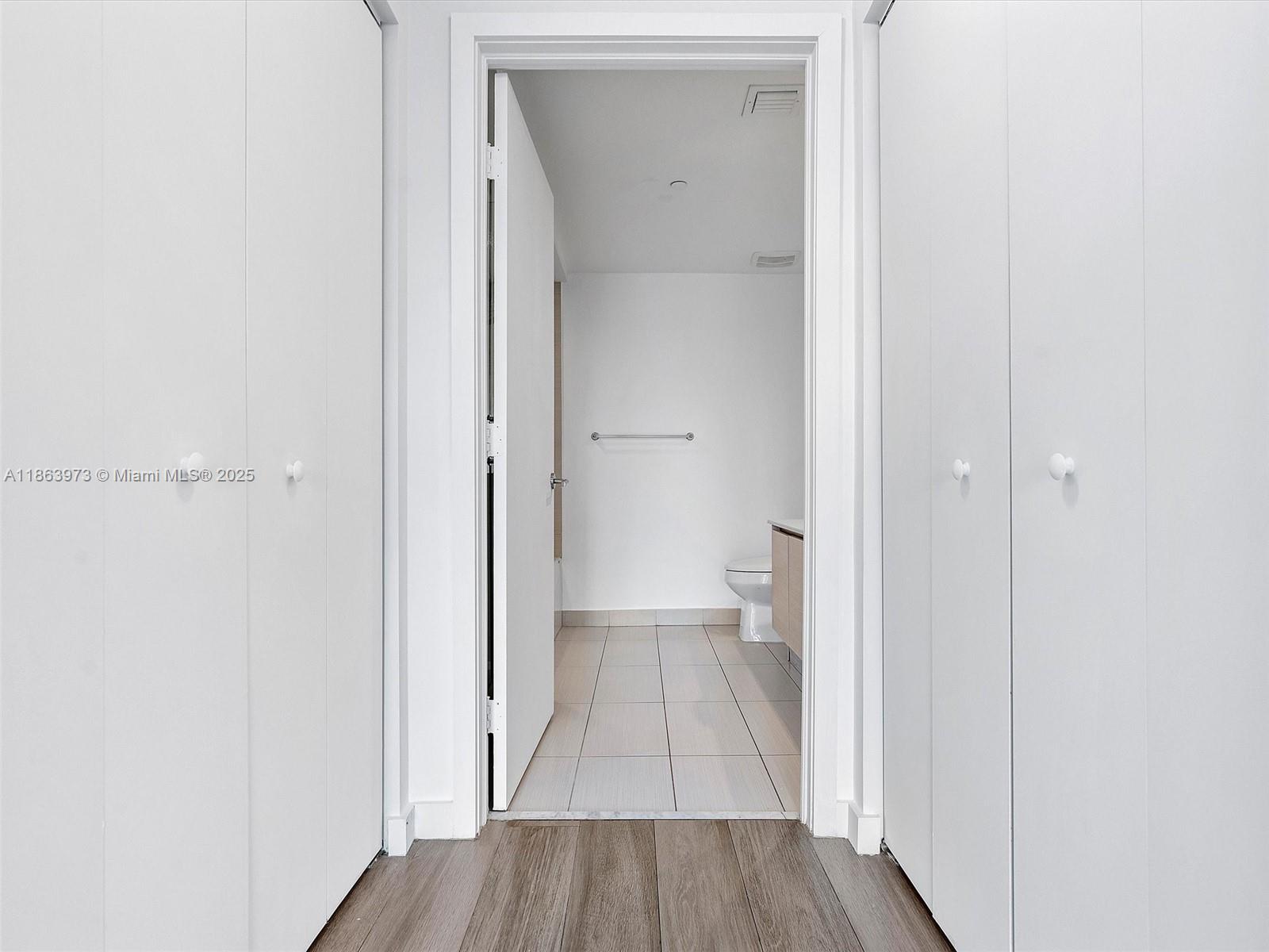 4250 Biscayne Boulevard, Unit 1416 Miami, FL 33137 - Photo 24 of 55 a view of a hallway with wooden floor and a bathroom