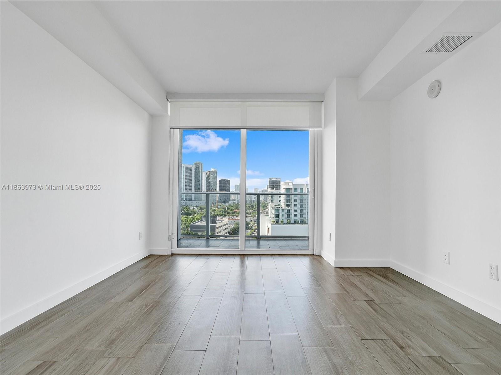4250 Biscayne Boulevard, Unit 1416 Miami, FL 33137 - Photo 32 of 55 a view of a room with wooden floor and a window